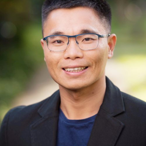 Headshot of Cary Wu smiling into the camera